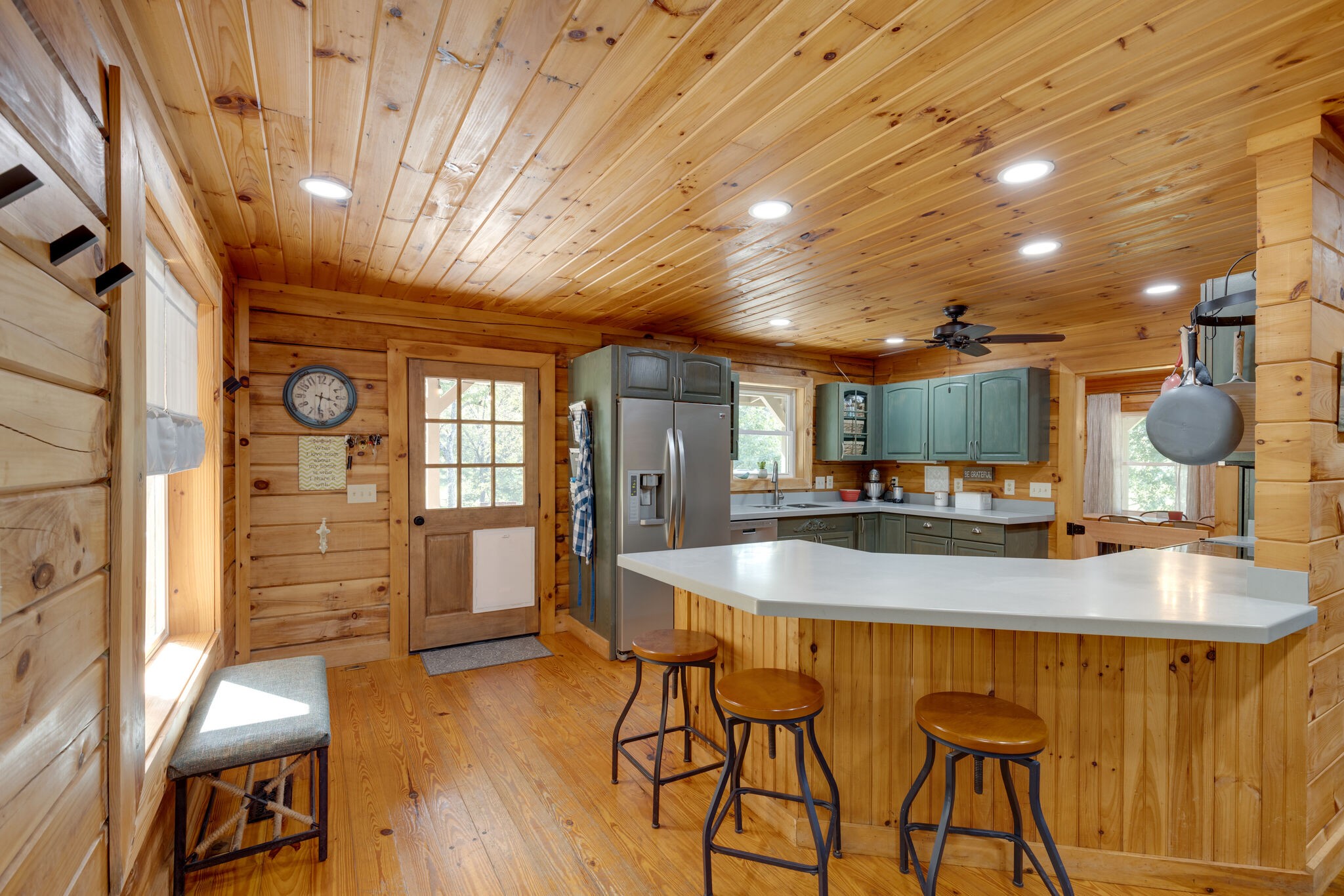 4520 Dugger Road Culleoka, TN 38451 - Photo 21 of 40 a dining hall with stainless steel appliances kitchen island granite countertop a table chairs and a refrigerator