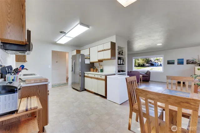 a kitchen with stainless steel appliances granite countertop a sink and cabinets
