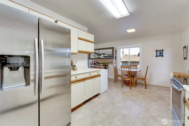 a bedroom with a bed and a couch next to a window