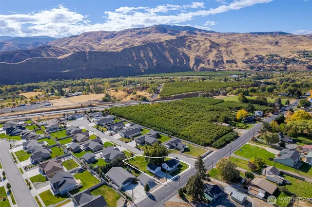 an aerial view of a swimming pool with a yard