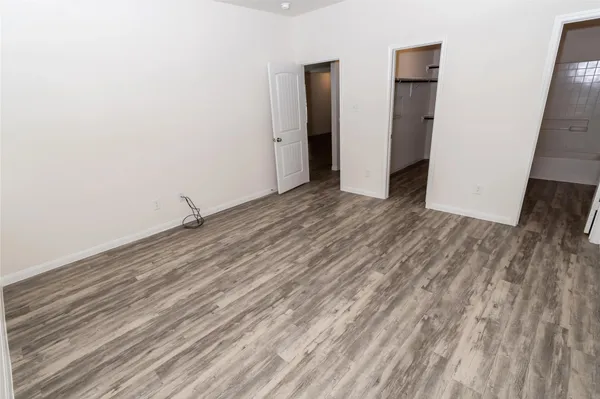 a view of a room with wooden floor and brick wall