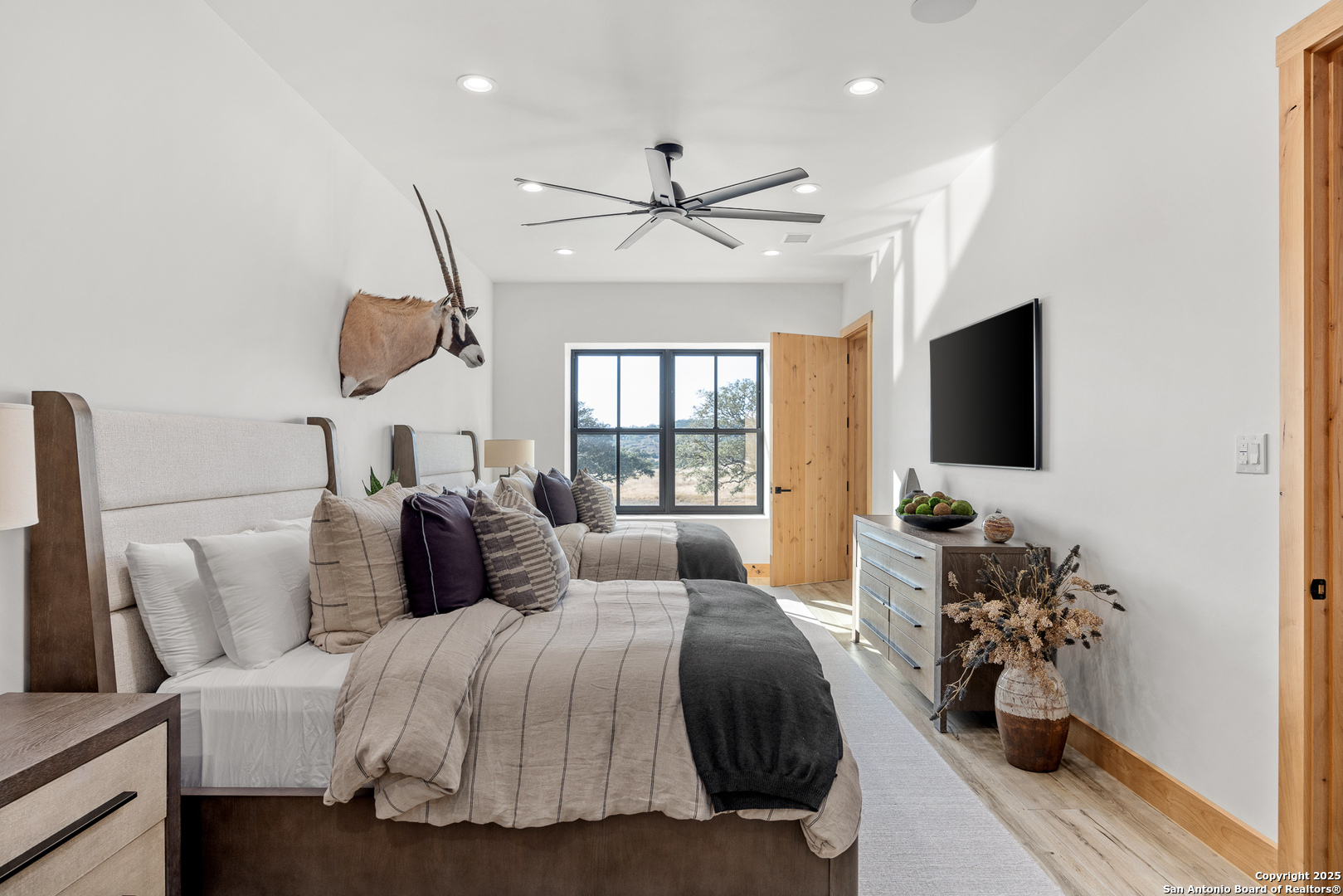 3280 Highway 39 Hunt, TX 78024 - Photo 29 of 50 a bedroom with a bed and a chandelier