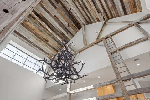 a living room with fireplace furniture and a large window