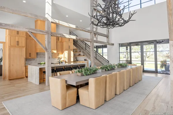 a living room with furniture fireplace and a large window