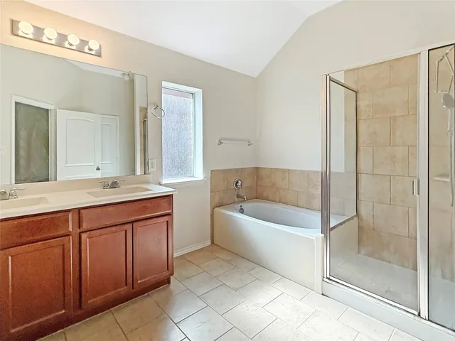 a bathroom with a granite countertop sink a toilet and shower