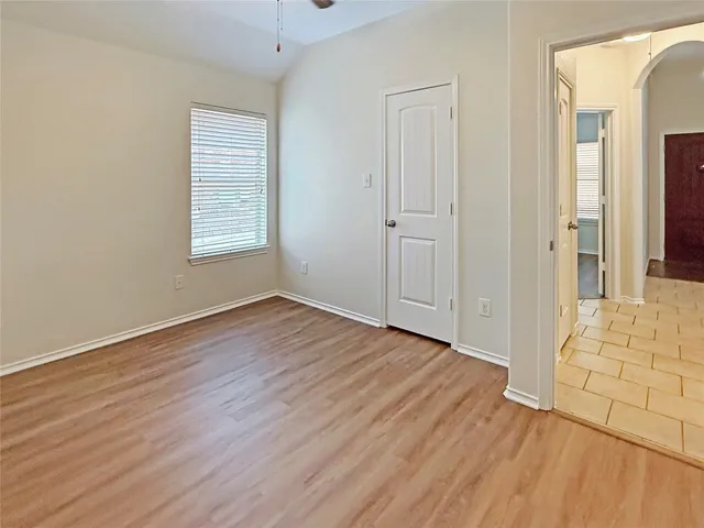 wooden floor in an empty room with a window
