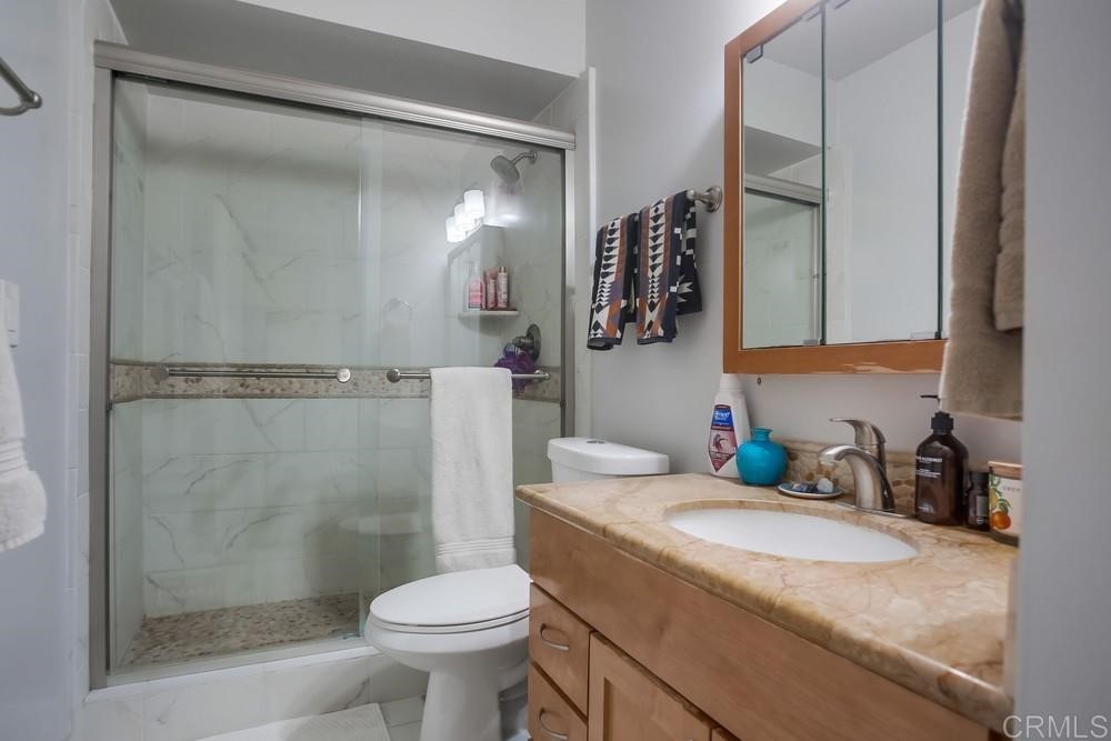 328 Hilmen Drive Solana Beach, CA 92075 - Photo 12 of 19 a bathroom with a granite countertop sink toilet and shower