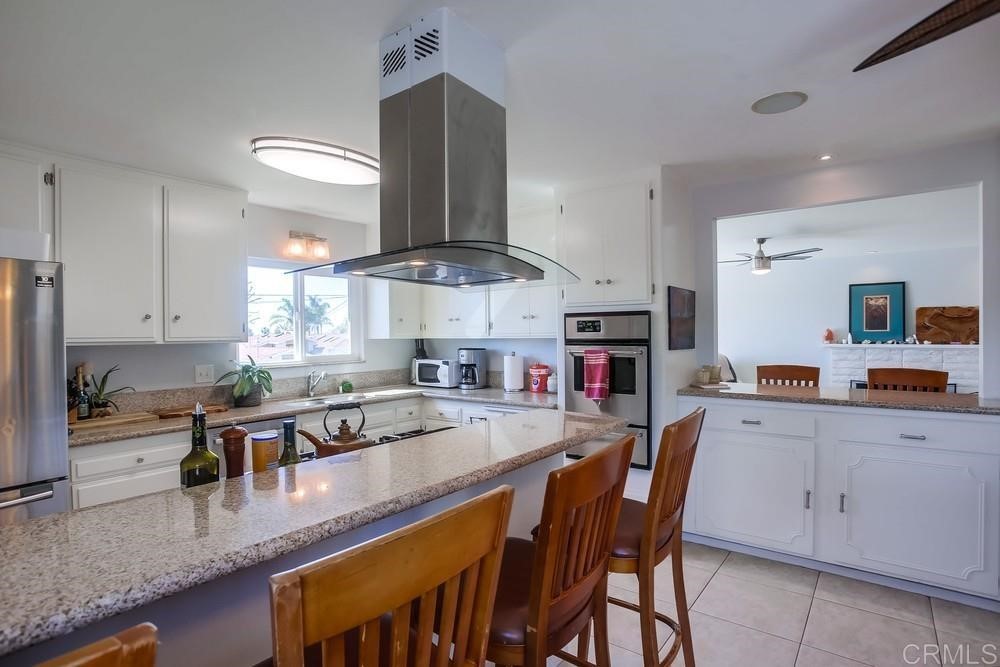 328 Hilmen Drive Solana Beach, CA 92075 - Photo 4 of 19 a kitchen with stainless steel appliances granite countertop a sink counter space and cabinets