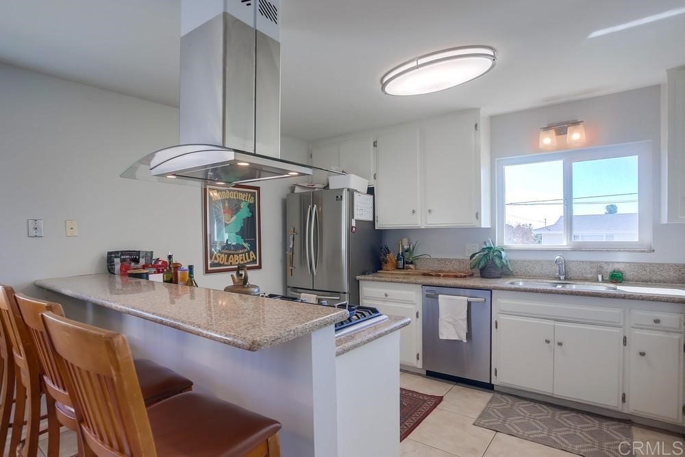 328 Hilmen Drive Solana Beach, CA 92075 - Photo 5 of 19 a kitchen with a sink cabinets and window