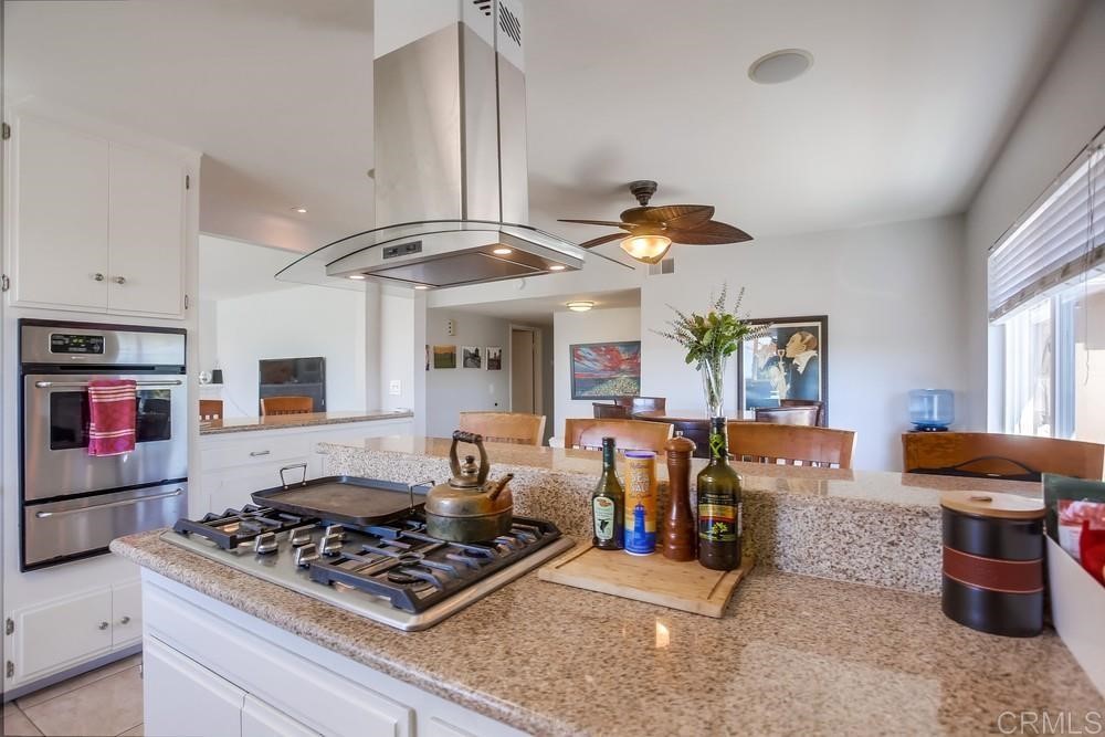 328 Hilmen Drive Solana Beach, CA 92075 - Photo 6 of 19 a kitchen with stainless steel appliances granite countertop a stove and a large window