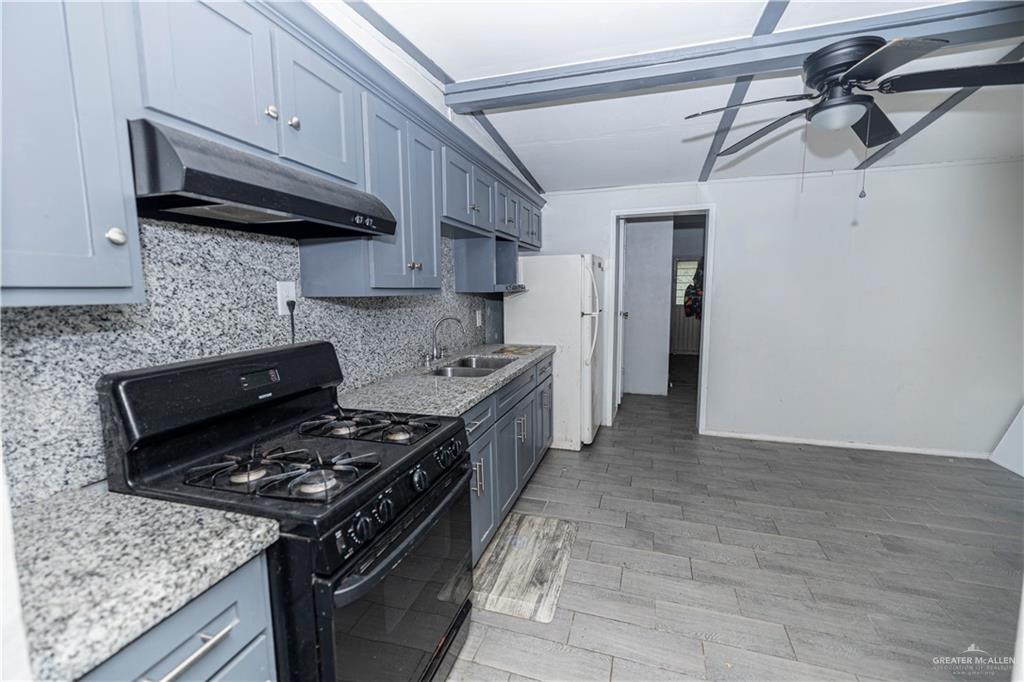 217 South Bridge Avenue Weslaco, TX 78596 - Photo 7 of 7 a kitchen with stainless steel appliances granite countertop a stove and a sink