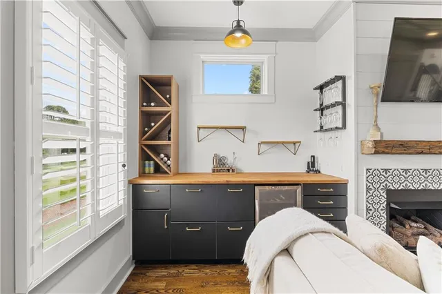 a kitchen with a sink dishwasher and a stove with wooden floor