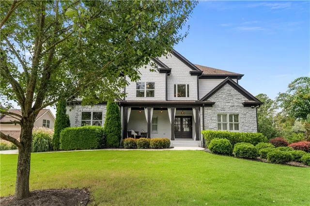 a front view of a house with a yard and garage