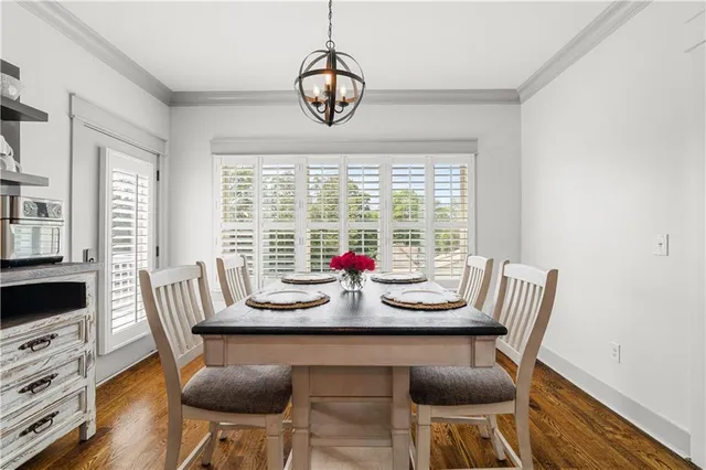 a living room with furniture a window and a flat screen tv