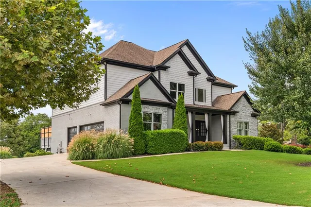a front view of a house with a garden