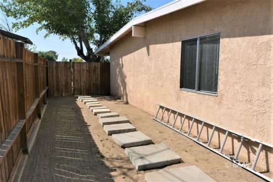 744 West Reeves Avenue Ridgecrest, CA 93555 - Photo 24 of 26 a view of a wooden floor with a white roof