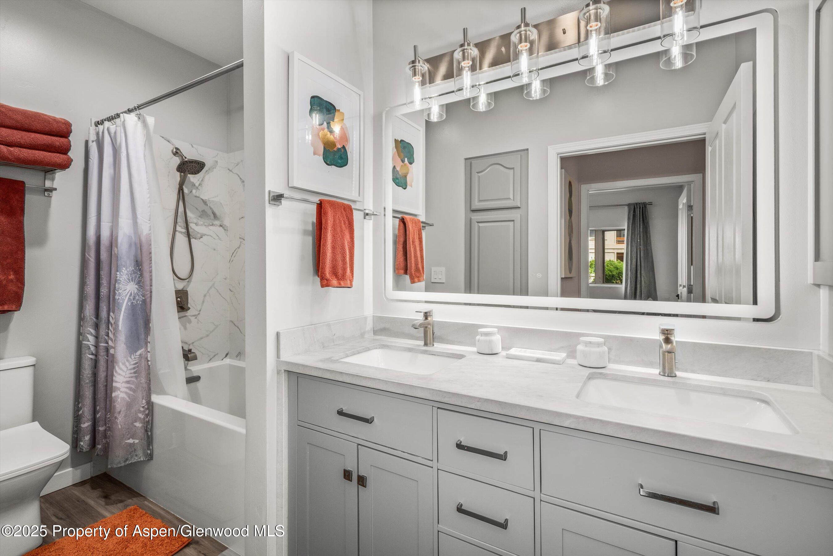 1400 East Valley Road, Unit 115 Basalt, CO 81621 - Photo 13 of 17 a bathroom with a sink double vanity granite tub shower and a mirror