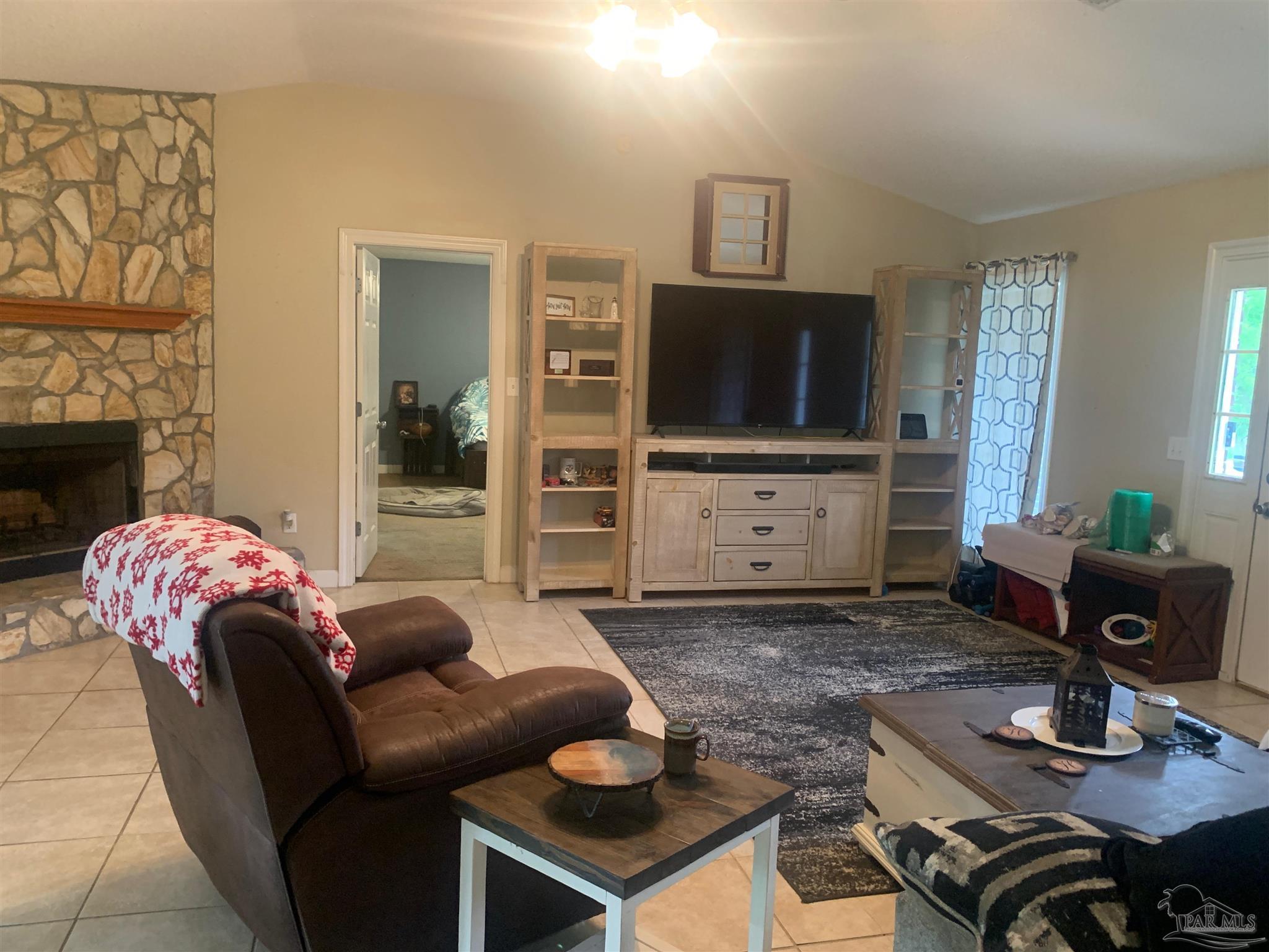 5154 Seneca Trail Milton, FL 32583 - Photo 11 of 20 a living room with furniture and a flat screen tv