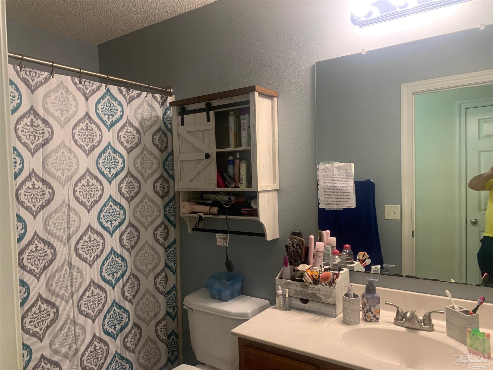 5154 Seneca Trail Milton, FL 32583 - Photo 13 of 20 a bathroom with a sink mirror vanity and toilet