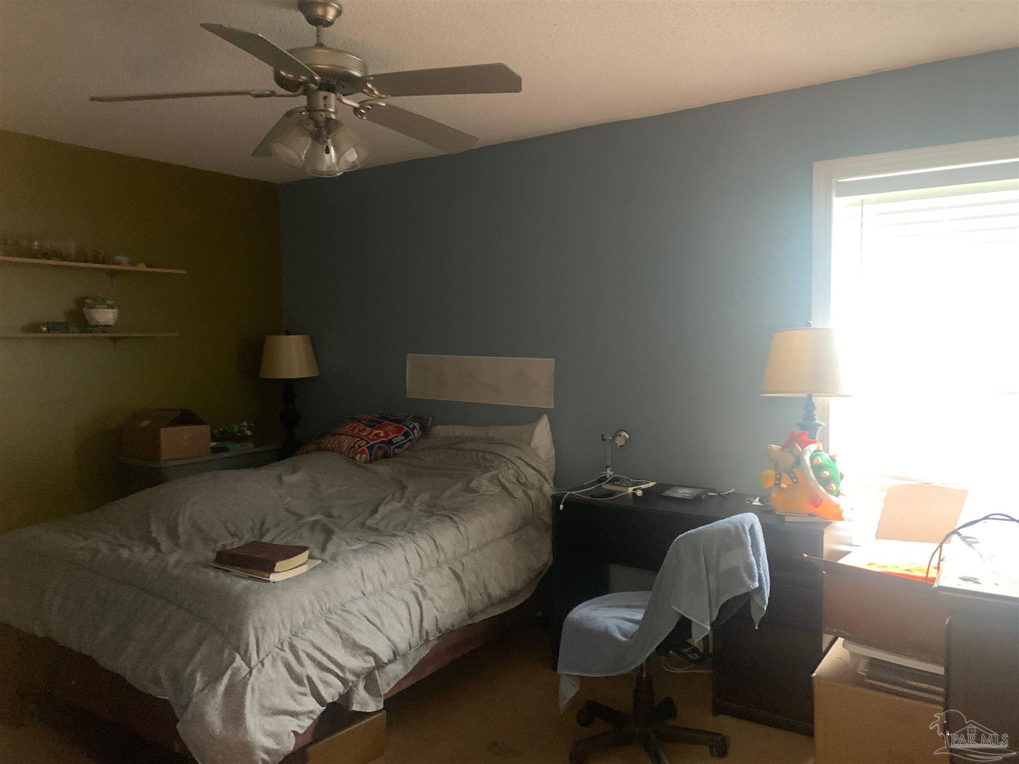 5154 Seneca Trail Milton, FL 32583 - Photo 14 of 20 a bedroom with a bed and furniture