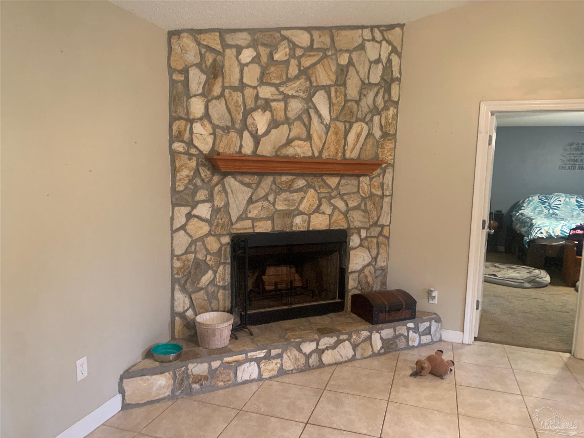 5154 Seneca Trail Milton, FL 32583 - Photo 16 of 20 a living room with furniture and a fireplace