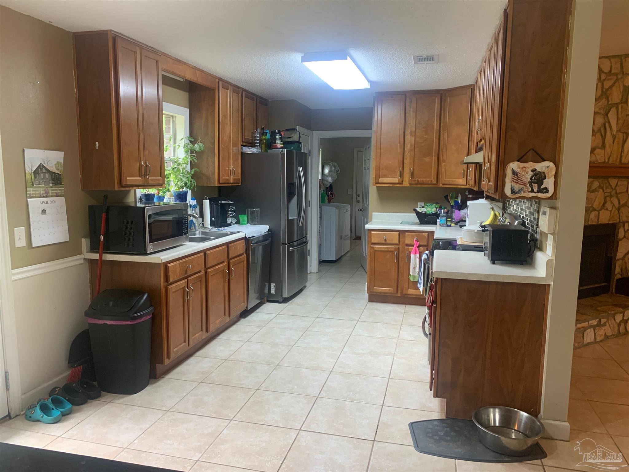5154 Seneca Trail Milton, FL 32583 - Photo 18 of 20 a kitchen with a sink cabinets and appliances