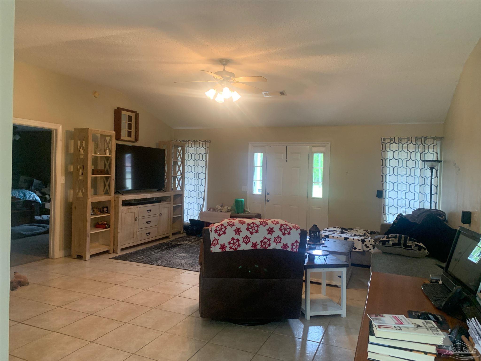 5154 Seneca Trail Milton, FL 32583 - Photo 4 of 20 a living room with furniture and a flat screen tv