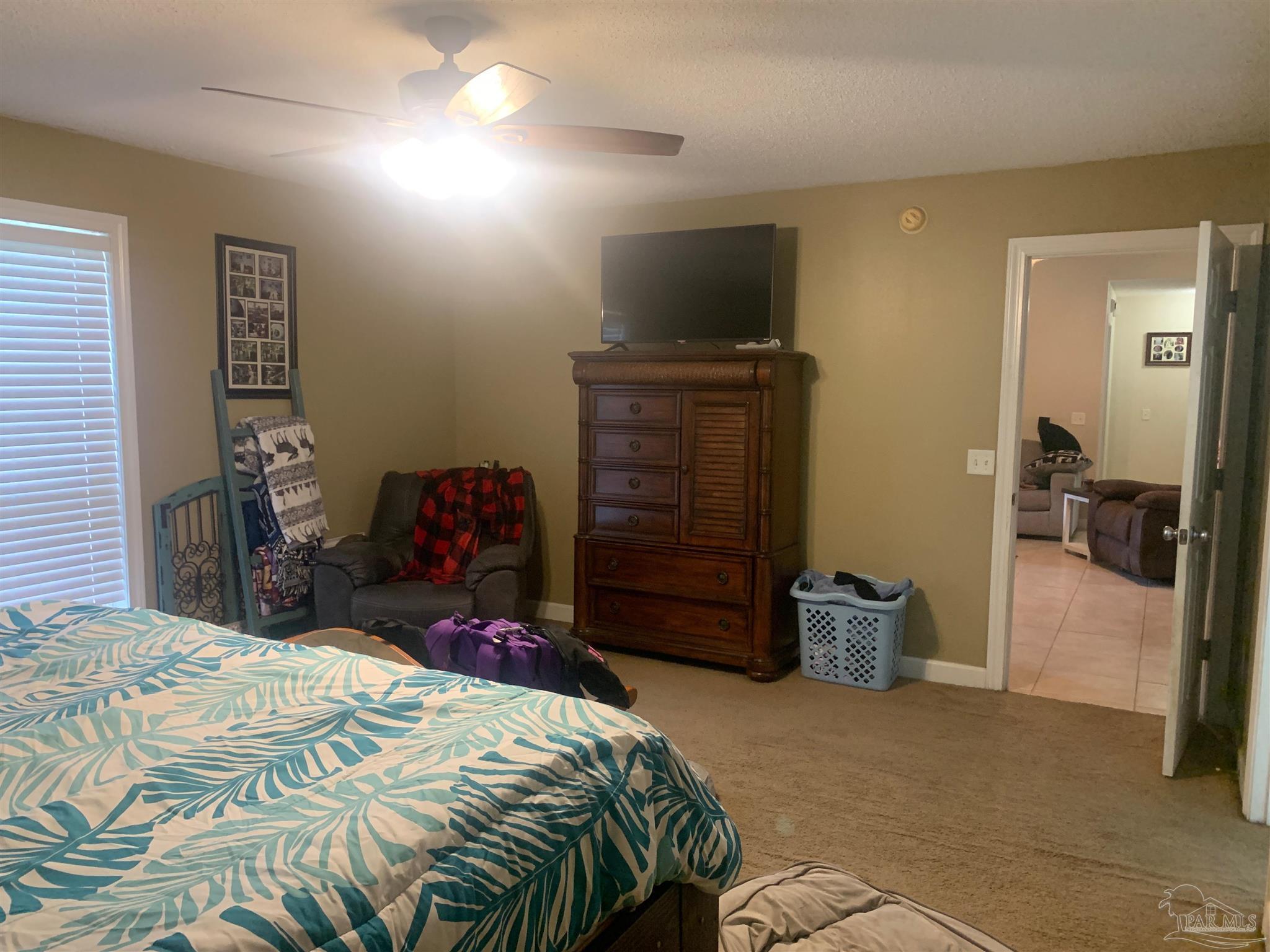 5154 Seneca Trail Milton, FL 32583 - Photo 9 of 20 a bedroom with a bed and a television