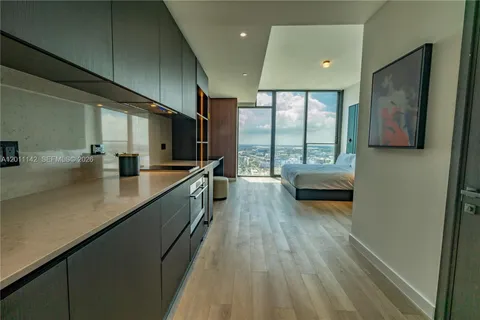 a bathroom with a double vanity sink and a large mirror