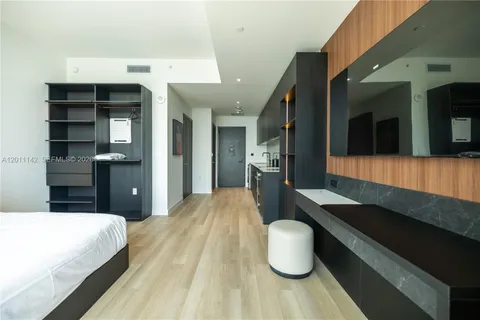 a bedroom with a bed and cabinets