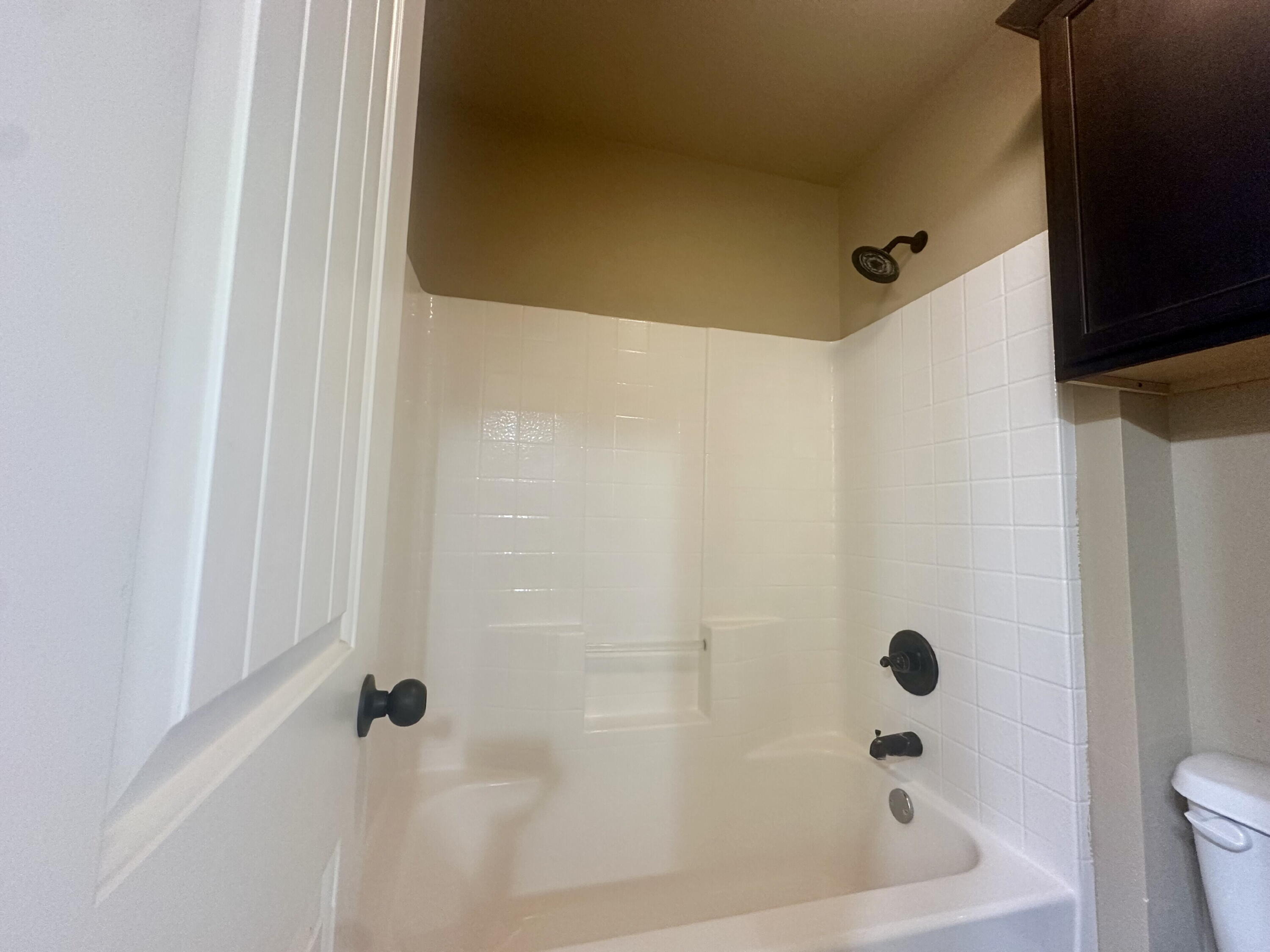 4423 106th Street, Unit A Lubbock, TX 79424 - Photo 22 of 23 a bathroom with a bathtub and a shower