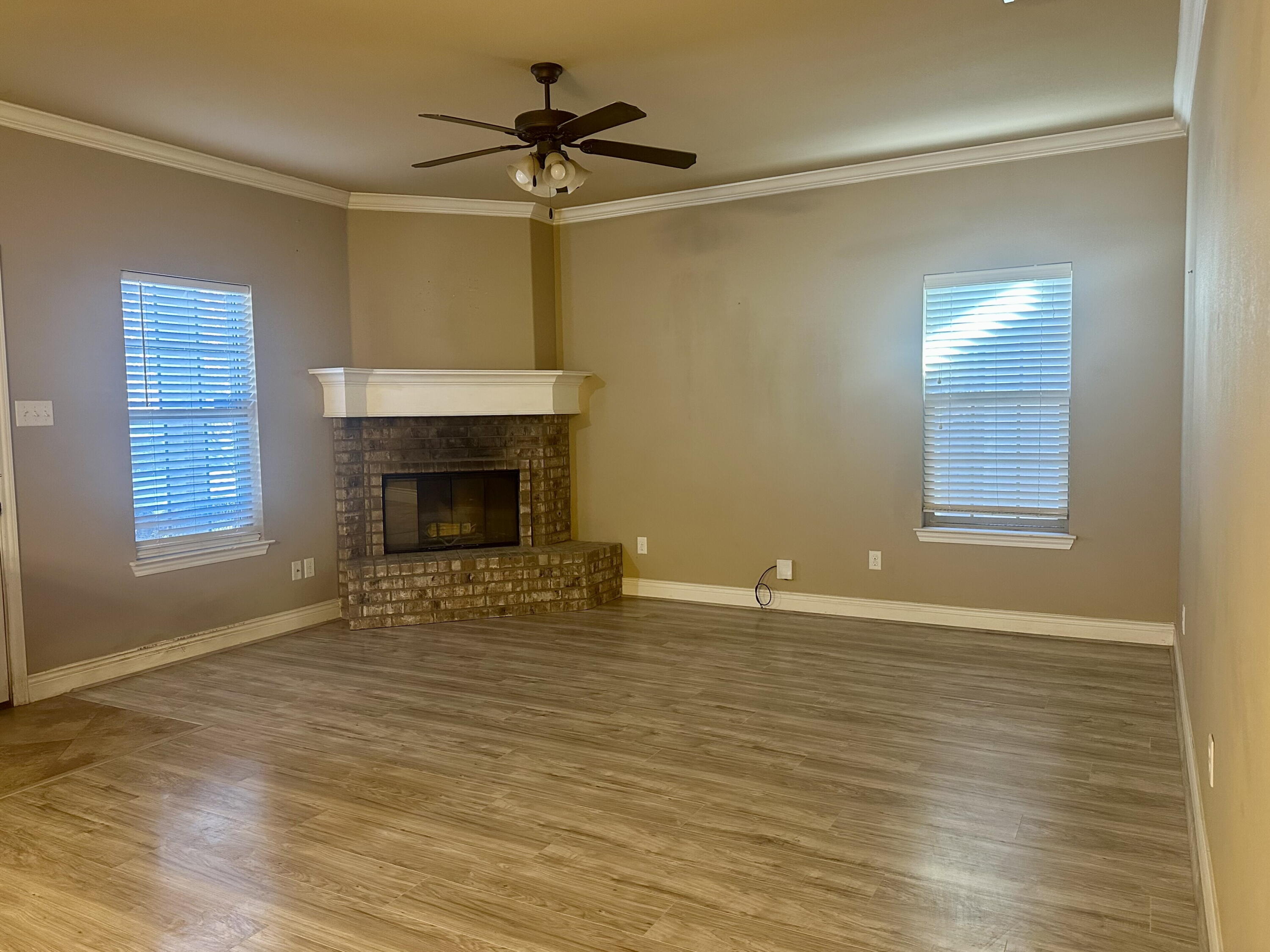 4423 106th Street, Unit A Lubbock, TX 79424 - Photo 5 of 23 a view of an empty room with a fireplace and a window