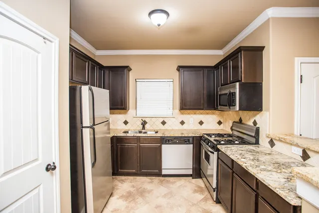 an empty room with a window and a ceiling fan