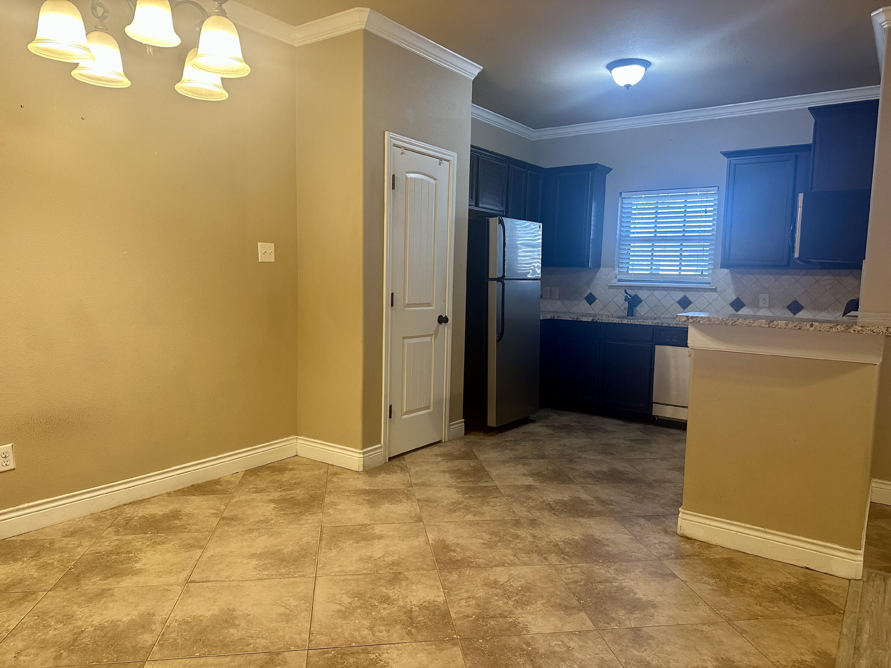 4423 106th Street, Unit A Lubbock, TX 79424 - Photo 7 of 23 a view of a kitchen with refrigerator and windows