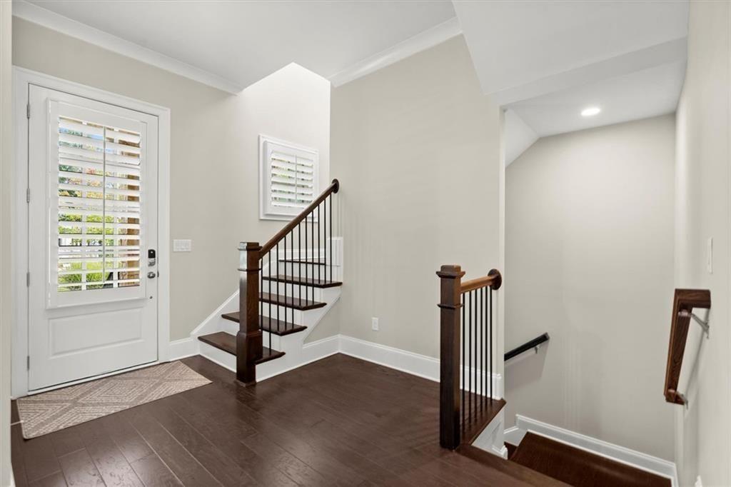 293 Thompson Street Alpharetta, GA 30009 - Photo 9 of 71 a view of a hallway with wooden floor and stairs