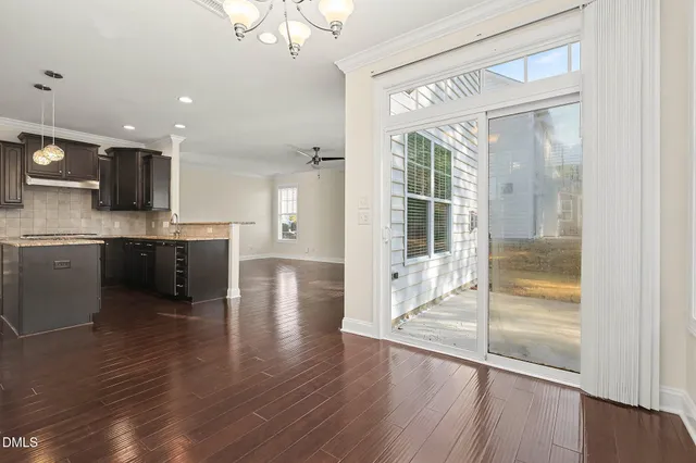 a open kitchen with wooden floor and a window