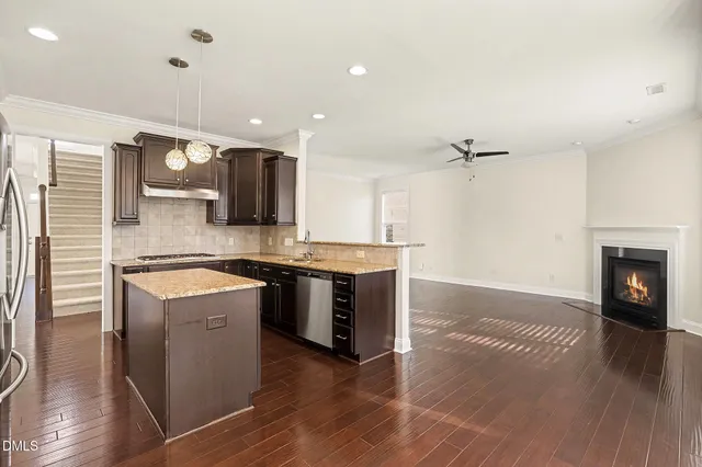 a large kitchen with stainless steel appliances granite countertop a stove a sink and a refrigerator