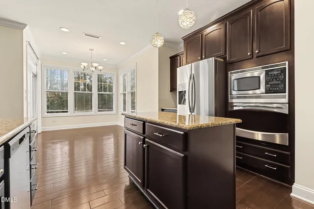 a kitchen with stainless steel appliances granite countertop a refrigerator and a sink