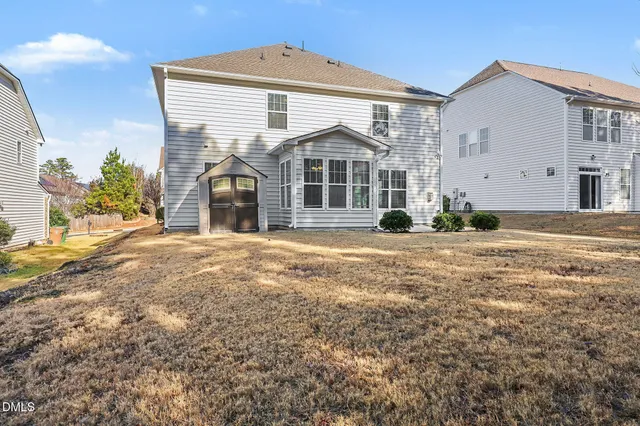 a view of a backyard with large trees
