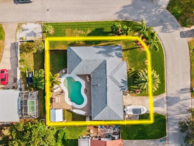 an aerial view of a house with a swimming pool