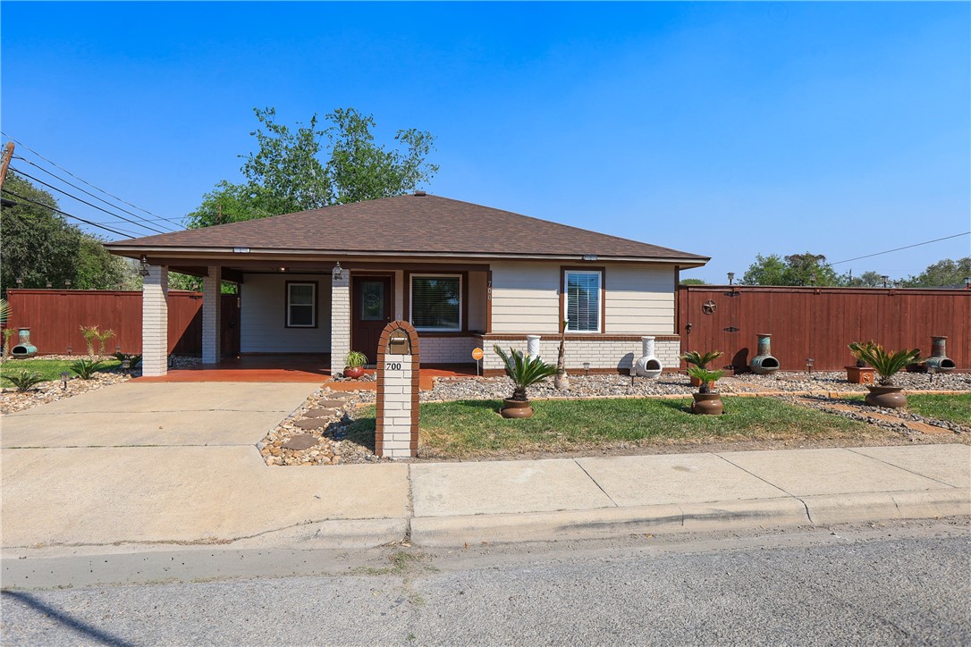 700 North Cameron Street Alice, TX 78332 - Photo 14 of 15 a front view of a house with a garden and patio