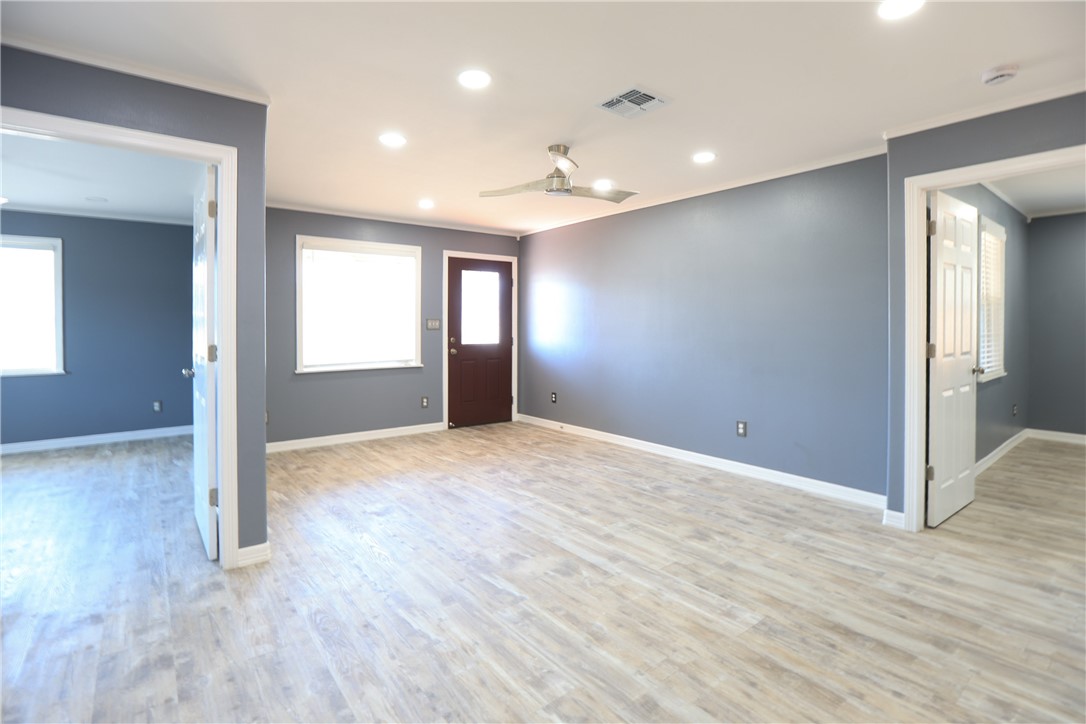 700 North Cameron Street Alice, TX 78332 - Photo 2 of 15 a view of empty room with wooden floor and fan