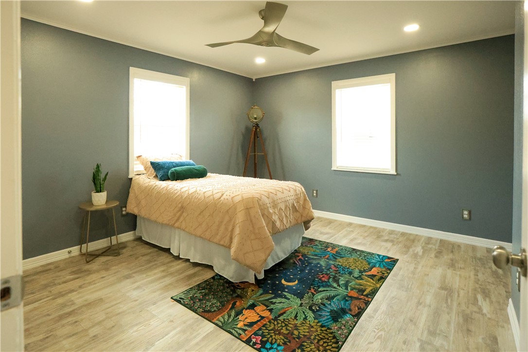 700 North Cameron Street Alice, TX 78332 - Photo 6 of 17 a bedroom with a bed and a chandelier