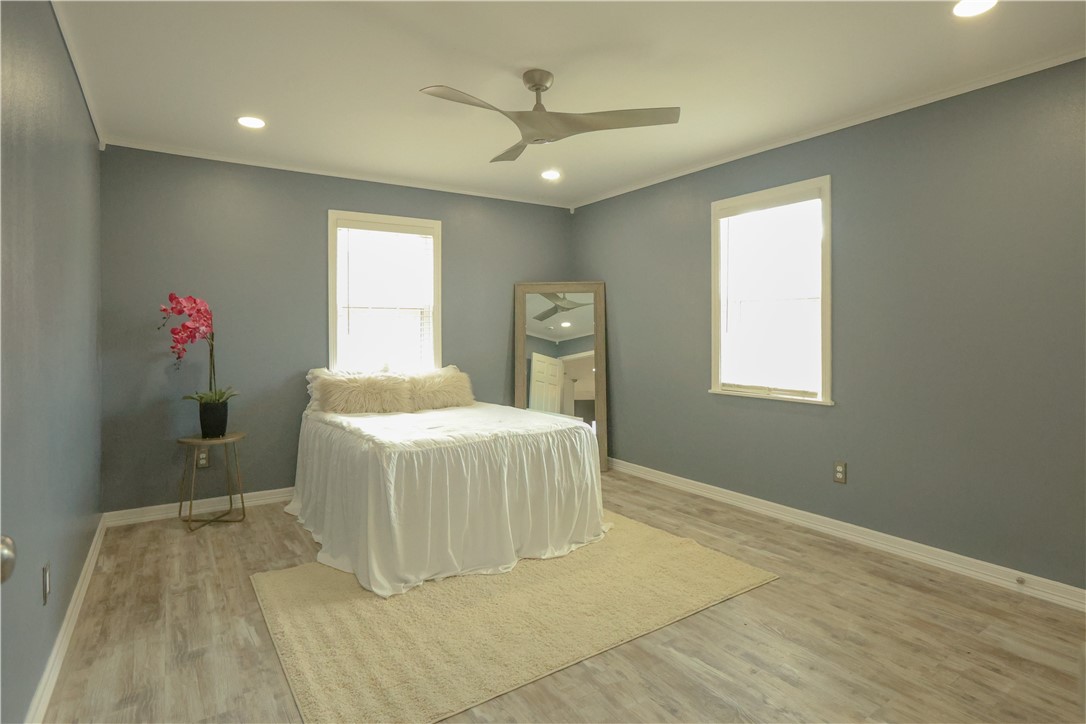 700 North Cameron Street Alice, TX 78332 - Photo 8 of 17 a spacious bedroom with a bed and a window