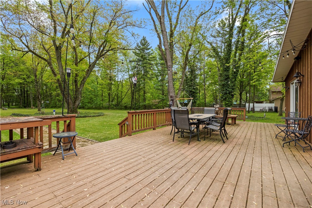 11811 Robson Road Grafton, OH 44044 - Photo 39 of 50 Deck featuring outdoor dining area and a yard