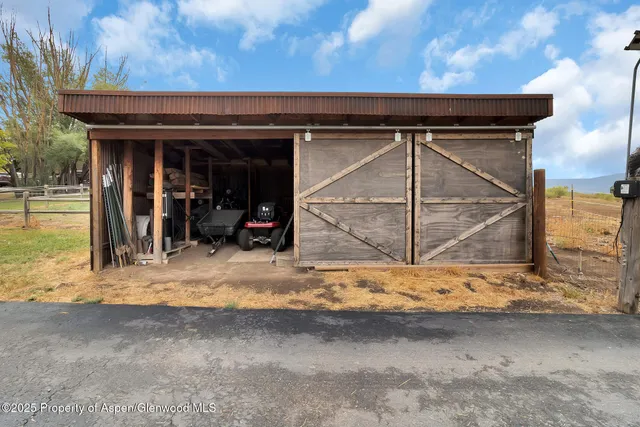 a view of a house with a wooden fence