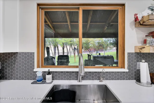 a bathroom with a sink and a large window