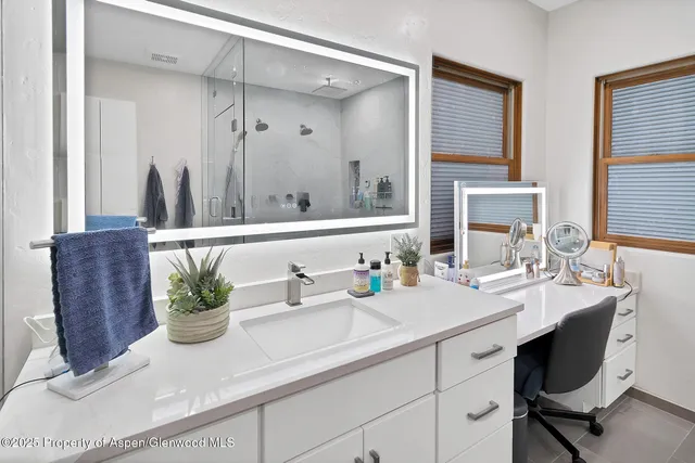 a bathroom with a sink a vanity and mirror