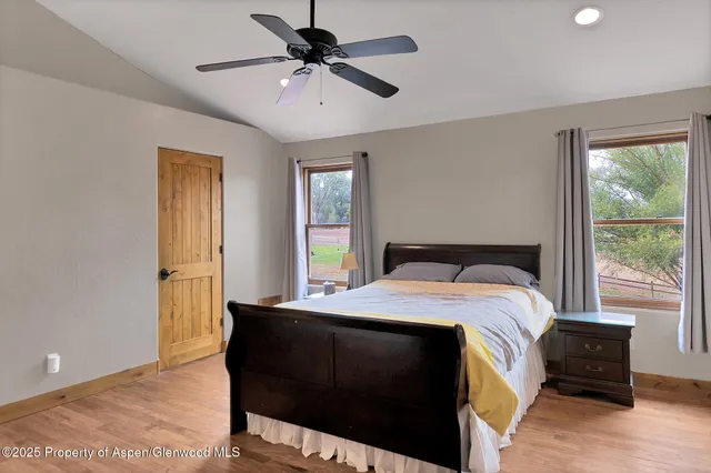 a bedroom with a bed and wooden floor
