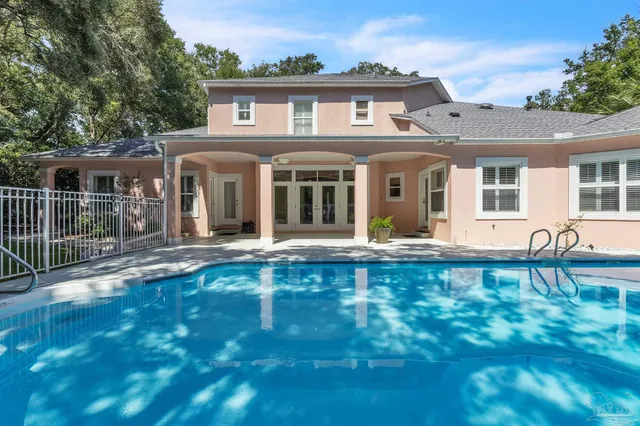 a view of a house with swimming pool and porch